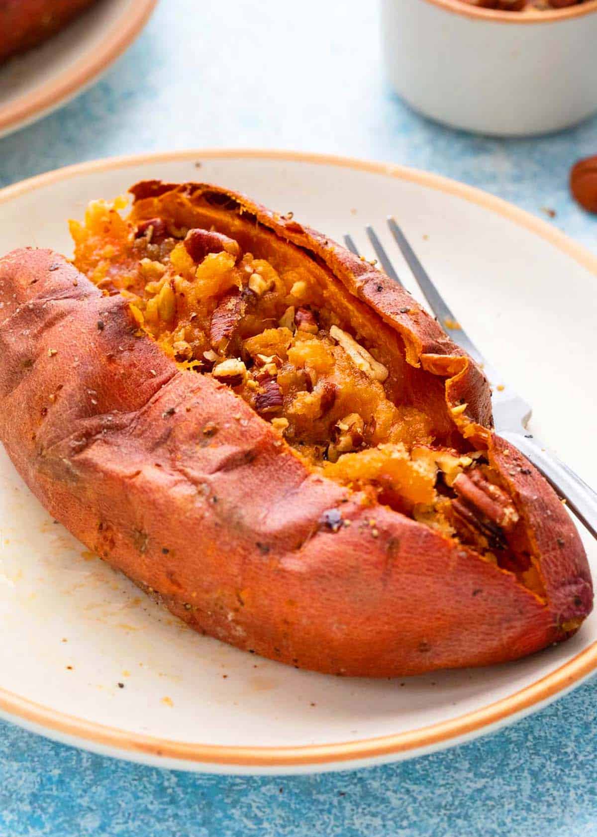 one baked sweet potato in a white plate.