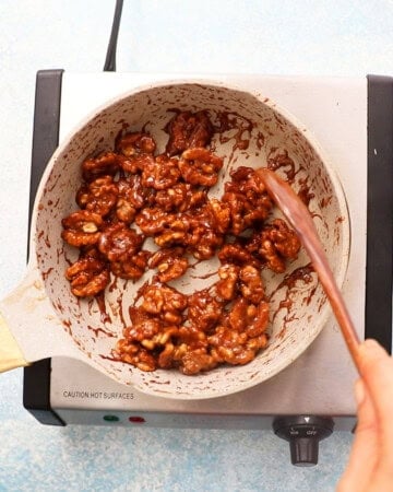 candied walnuts cooking in a skillet.