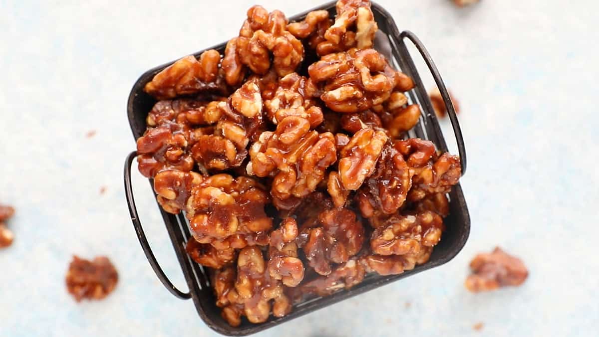 candied walnuts cooking in a basket.