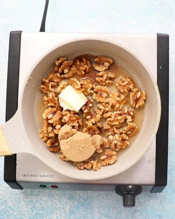 candied walnuts cooking in a skillet.