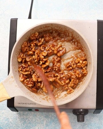 candied walnuts cooking in a skillet.