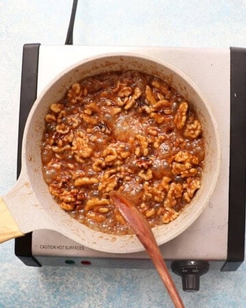 candied walnuts cooking in a skillet.