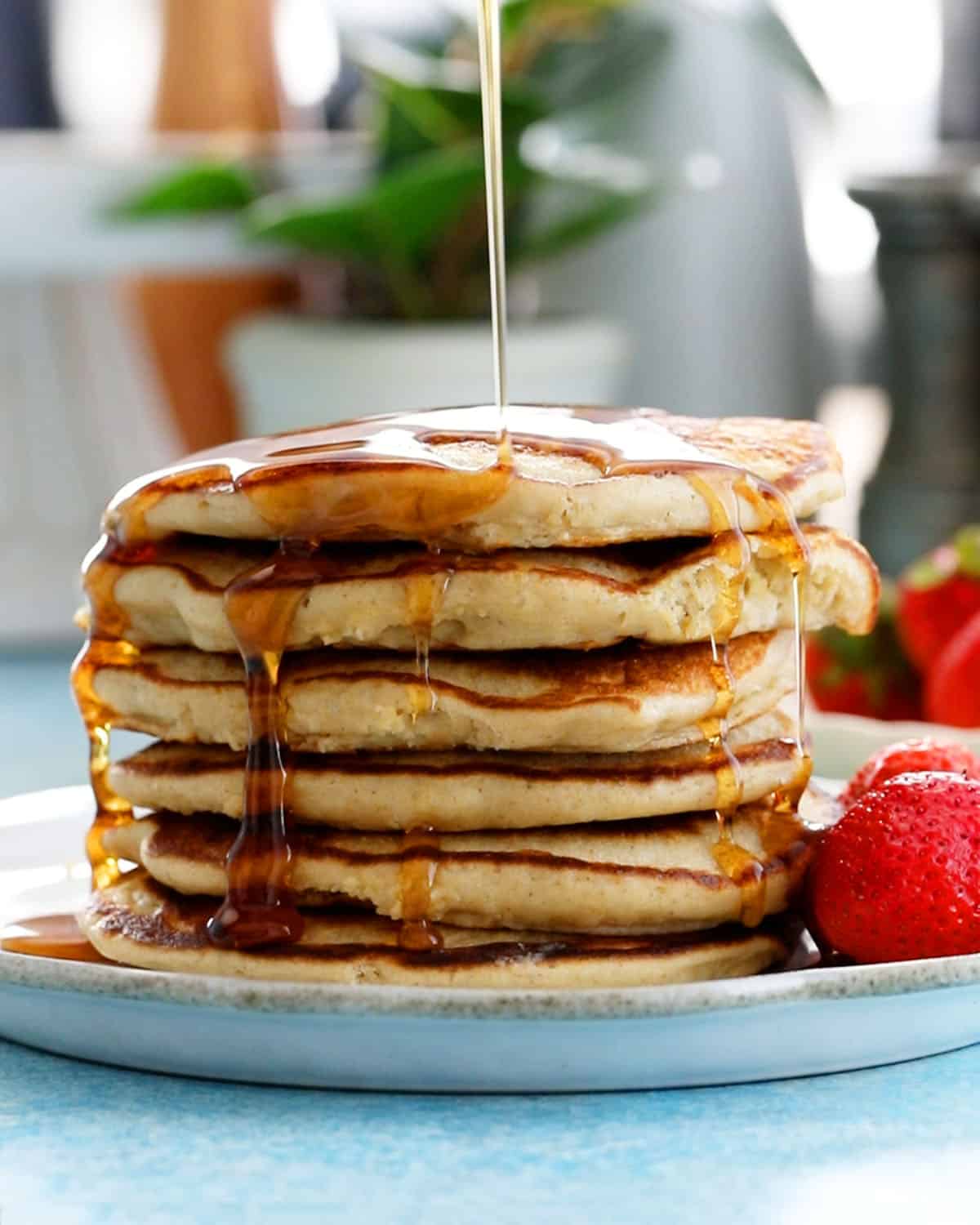 6 oat flour pancakes stacked in a white plate.