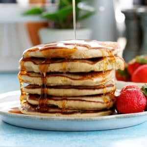 6 oat pancakes stacked in a white plate.