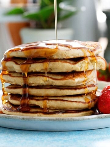 6 oat pancakes stacked in a white plate.