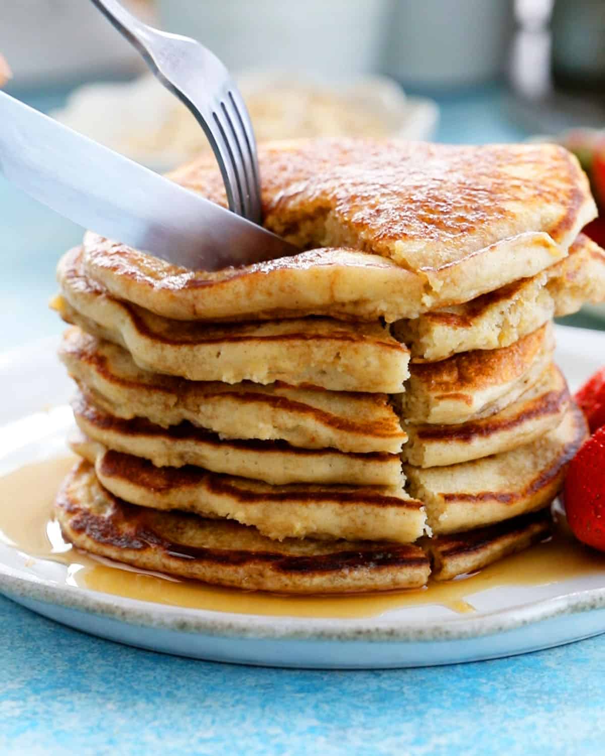 6 oat flour pancakes stacked in a white plate.