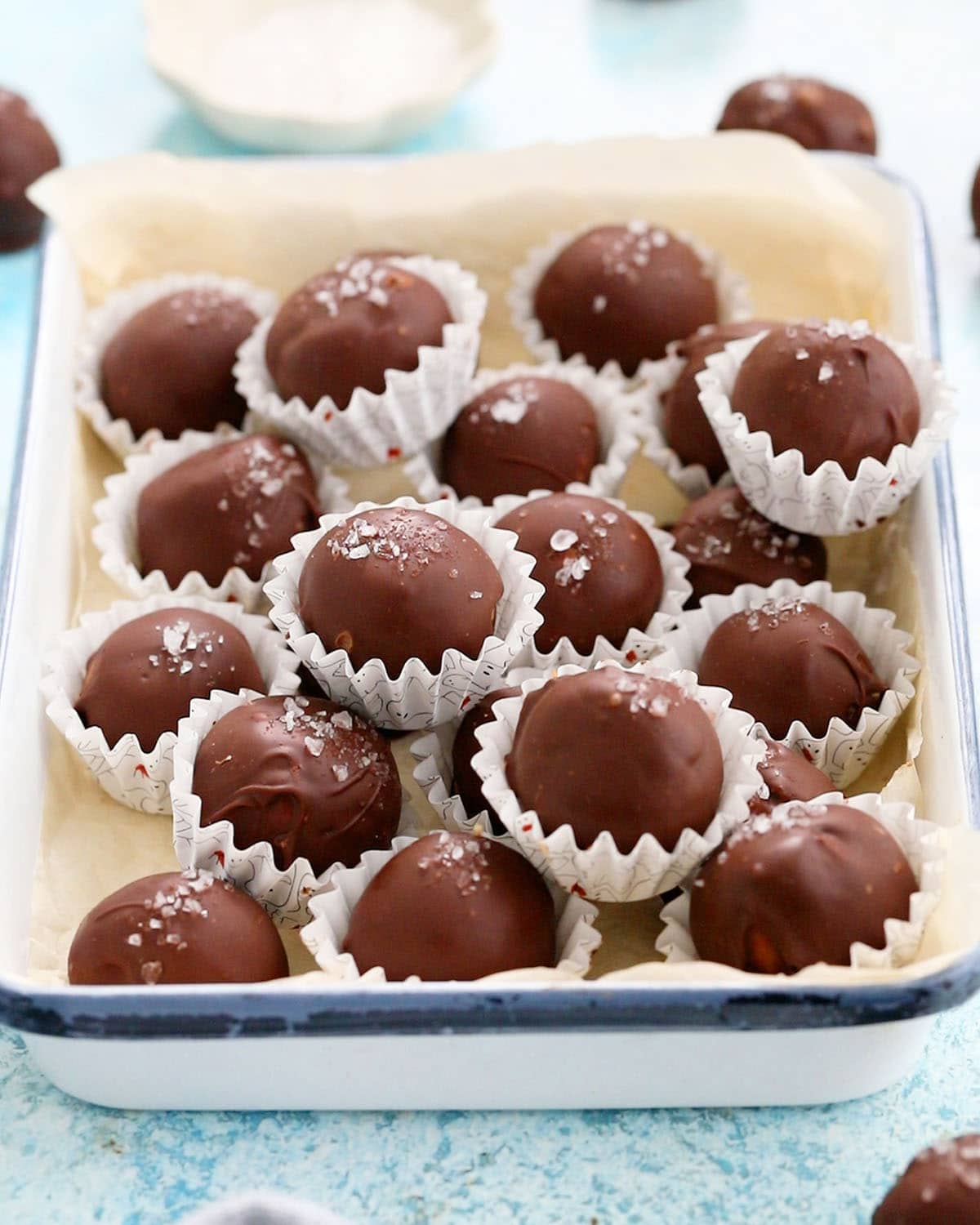 chocolate peanut butter balls in a white tray.