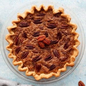 one pecan pie without corn syrup in a glass pie dish.