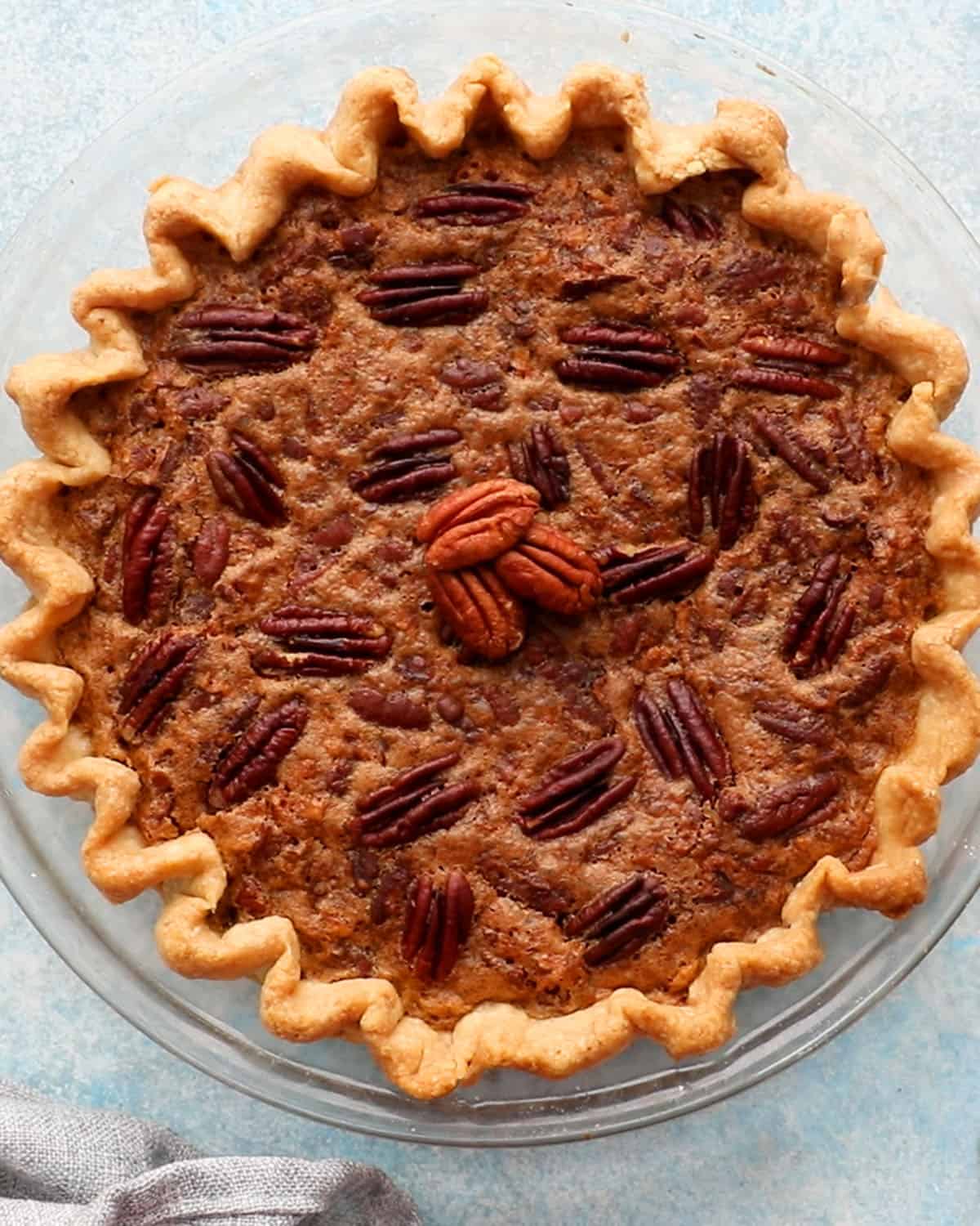 one baked pecan pie in a galss pie dish.