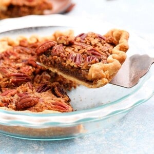 a slice of pecan pie being lifted from a pie plate.