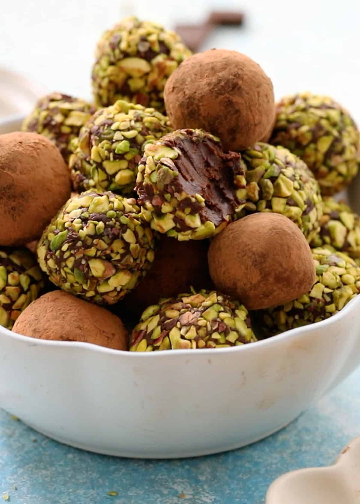 chocolate avocado truffles in a white bowl.