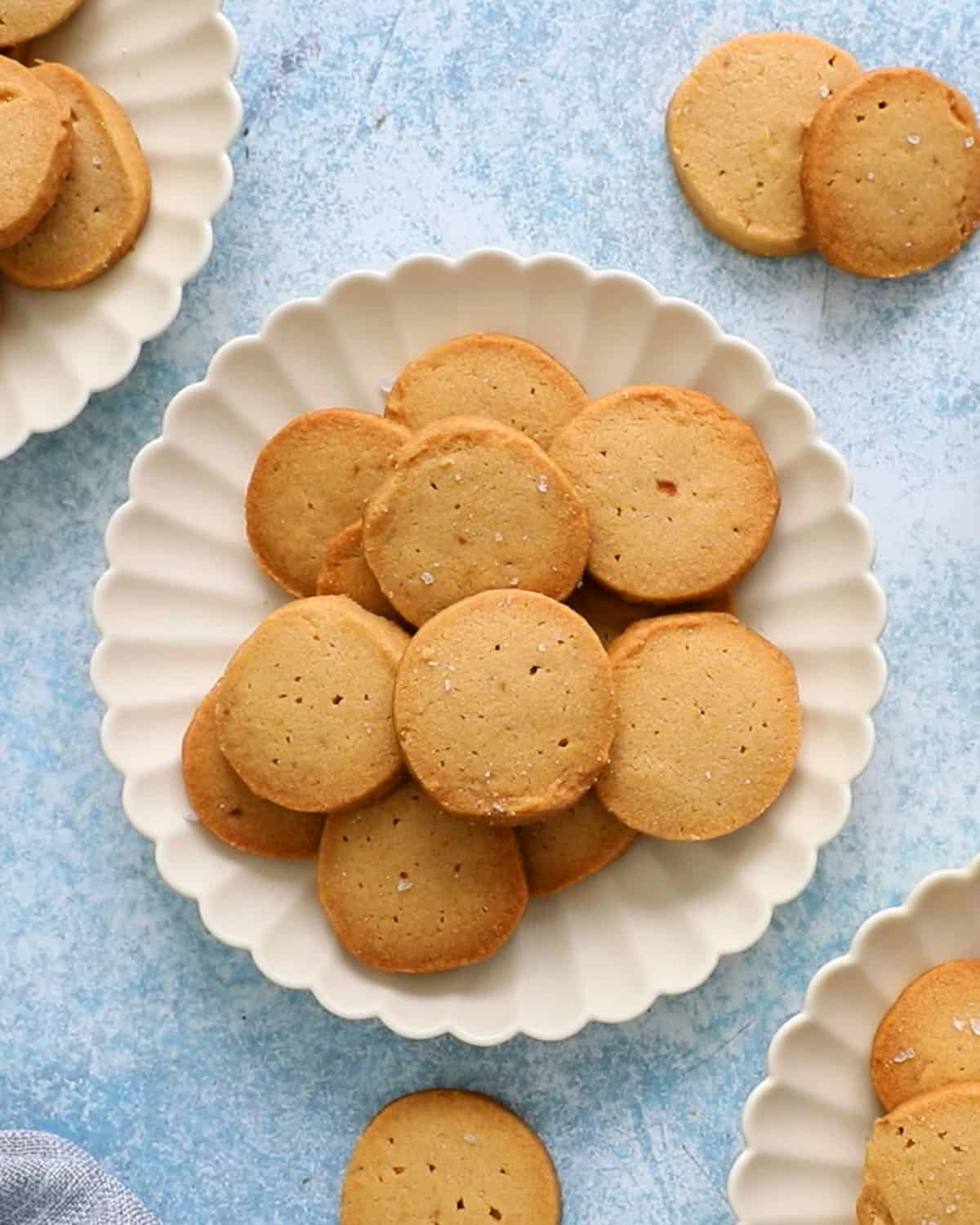 brown shortbread cookies placed in a white decorative plate.