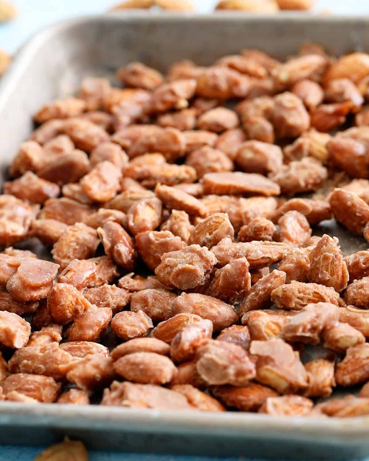 candied almonds in a metal sheet pan.