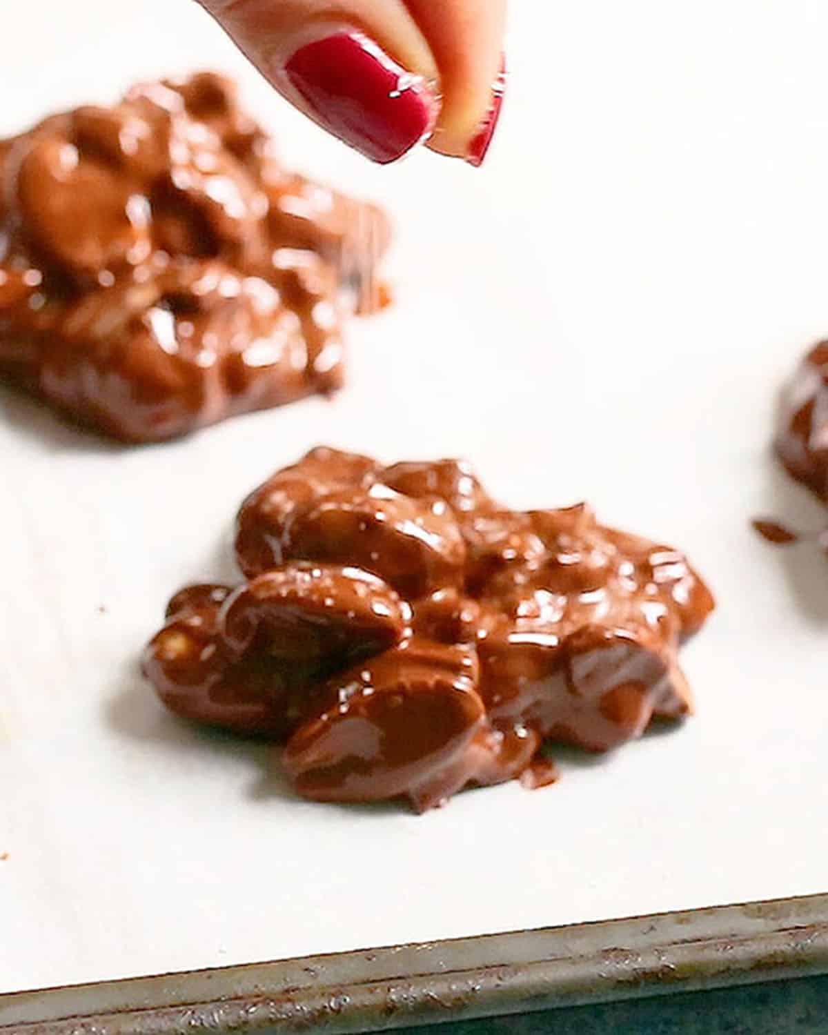 chocolate peanut clusters in a white sheet.