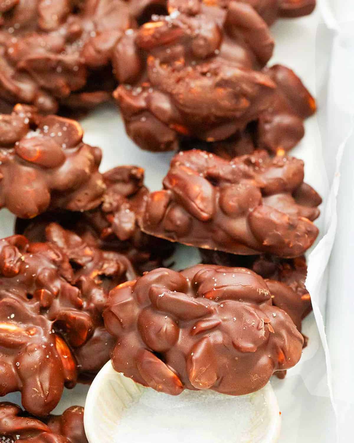 chocolate peanut clusters in a white tray.