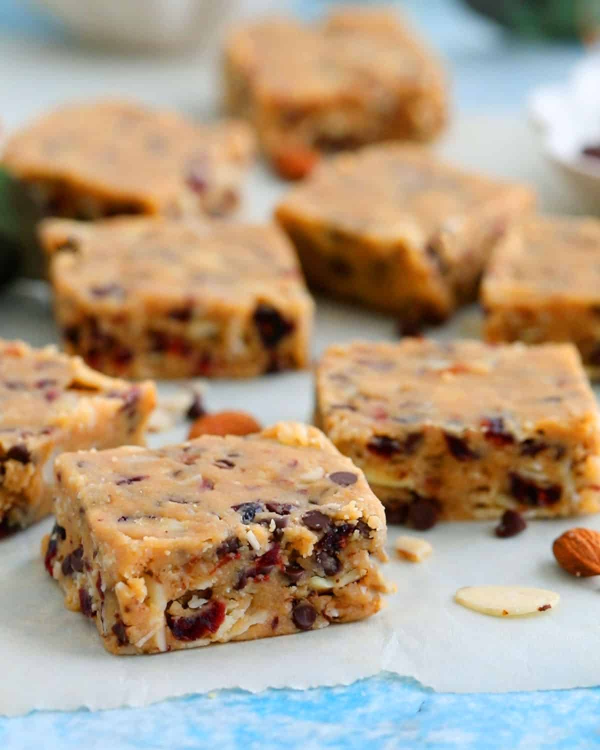 almond bar squares placed on a white parchment paper.