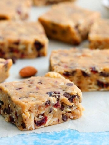 squares of brown almond bars placed on a white parchment paper.