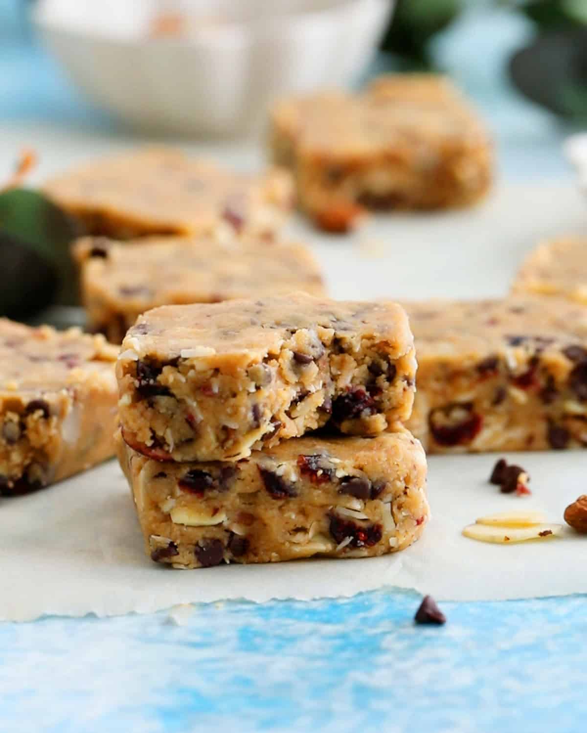 two brown almond squares on a white parchment paper.