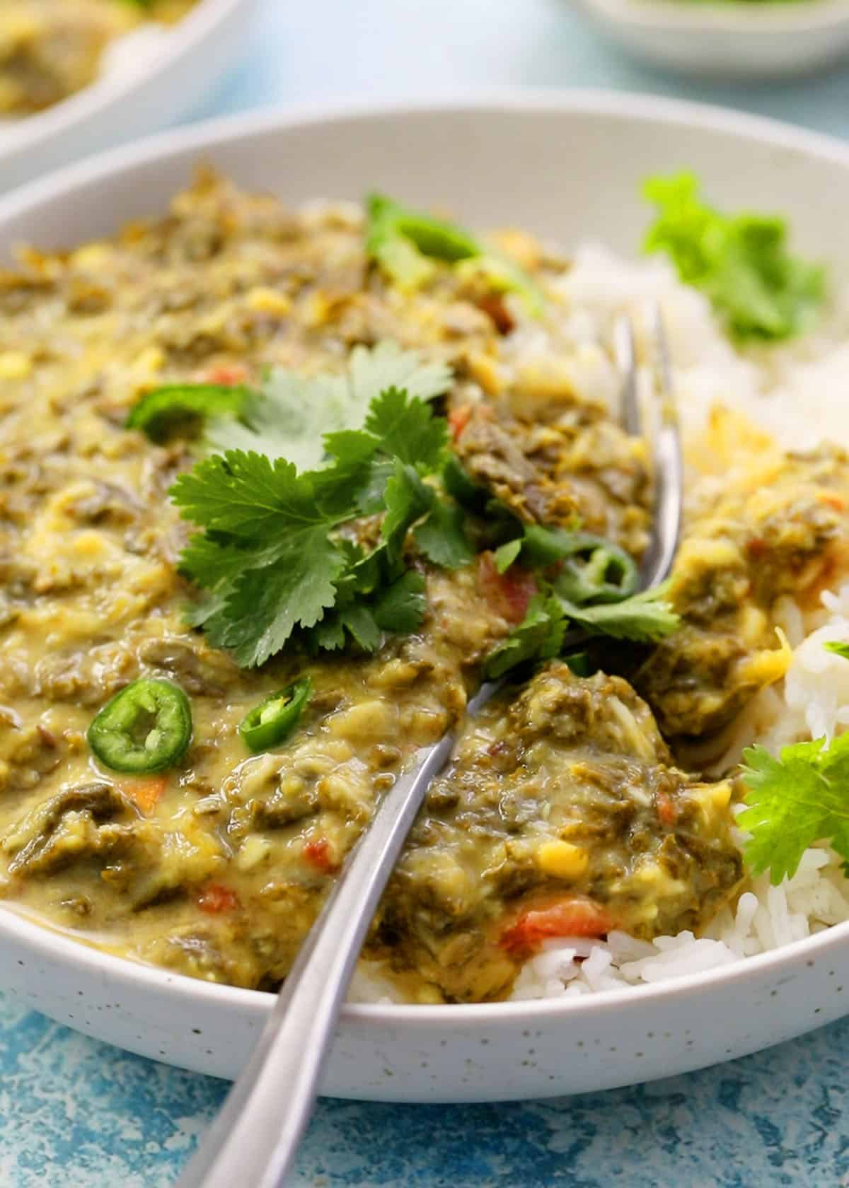 instant pot dal with kale in a white bowl.