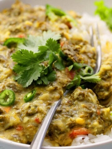 instant pot dal with kale in a white bowl.