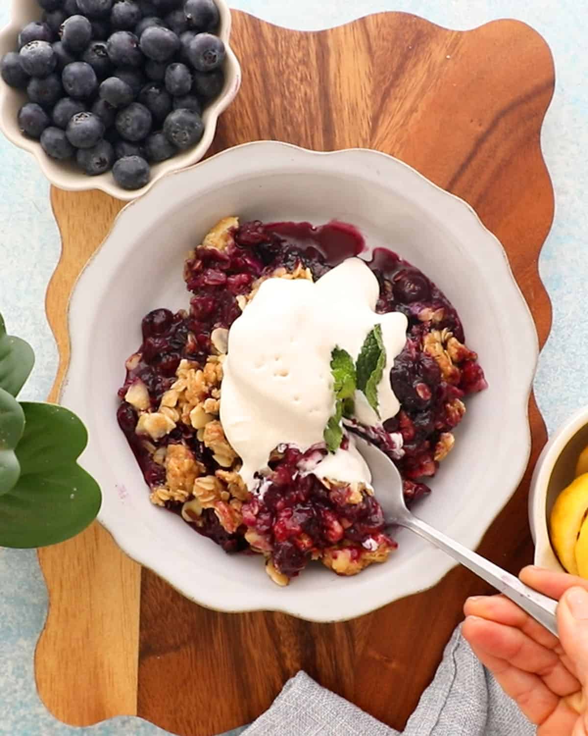 blueberry crisp in a white bowl.