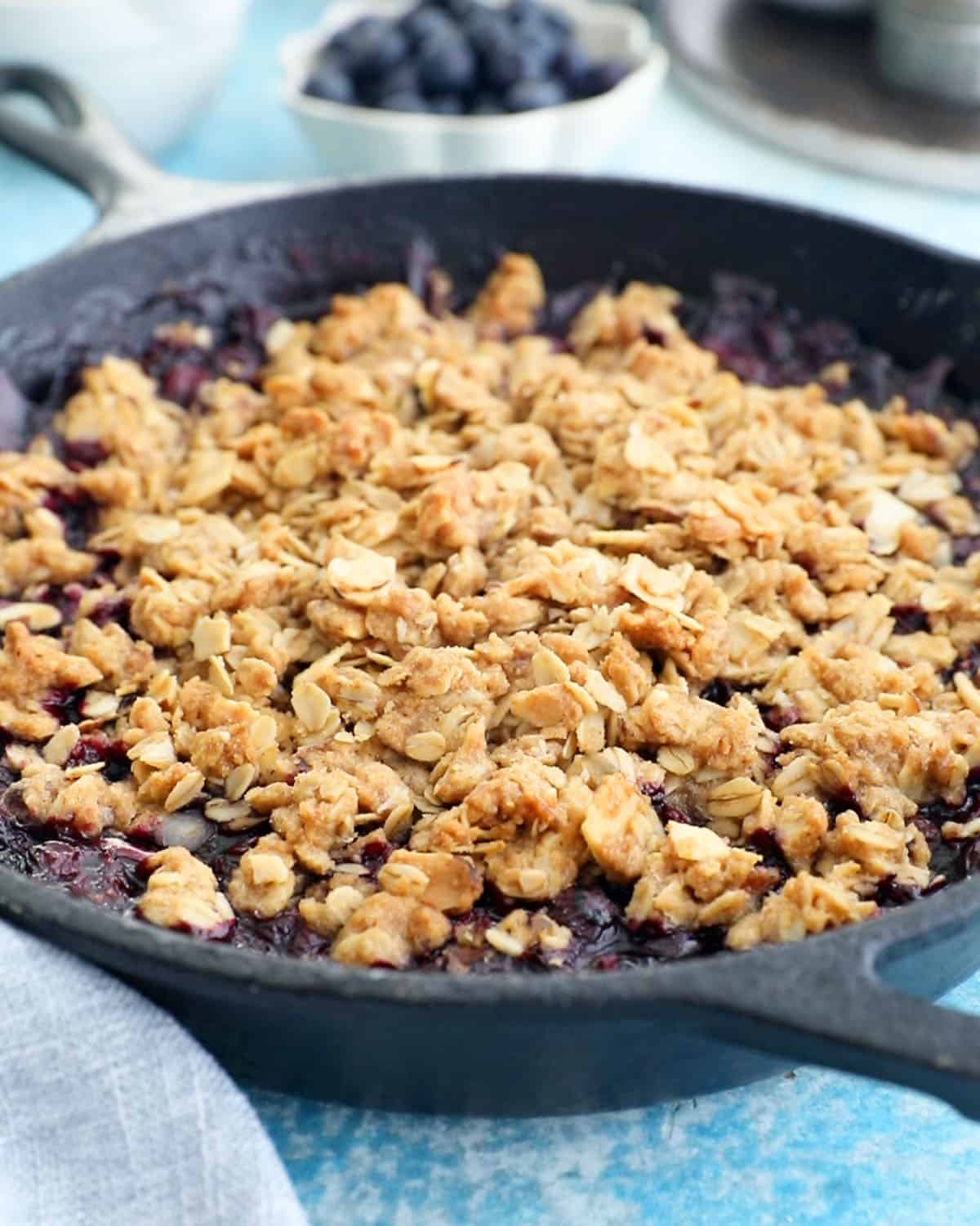 blueberry crisp in a black skillet.