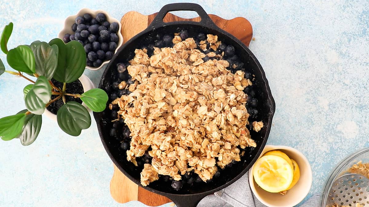 blueberry crisp in a black skillet.