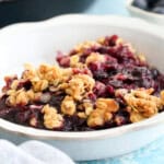 blueberry crisp in a white bowl.