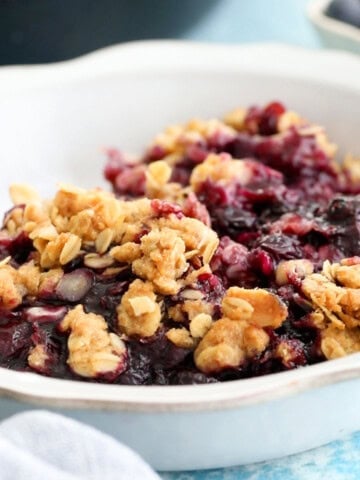 blueberry crisp in a white bowl.