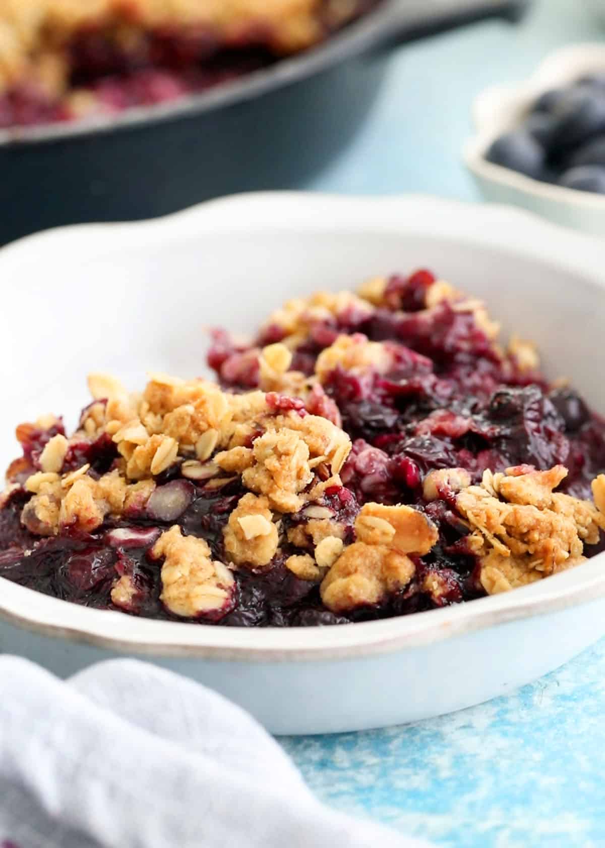 blueberry crisp in a white bowl.