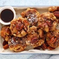 baked french toast muffins placed in a white rectangular tray.