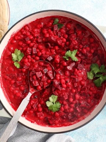 pink beet curry in a white pot.