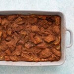 baked croissant bread pudding in a grey baking pan.