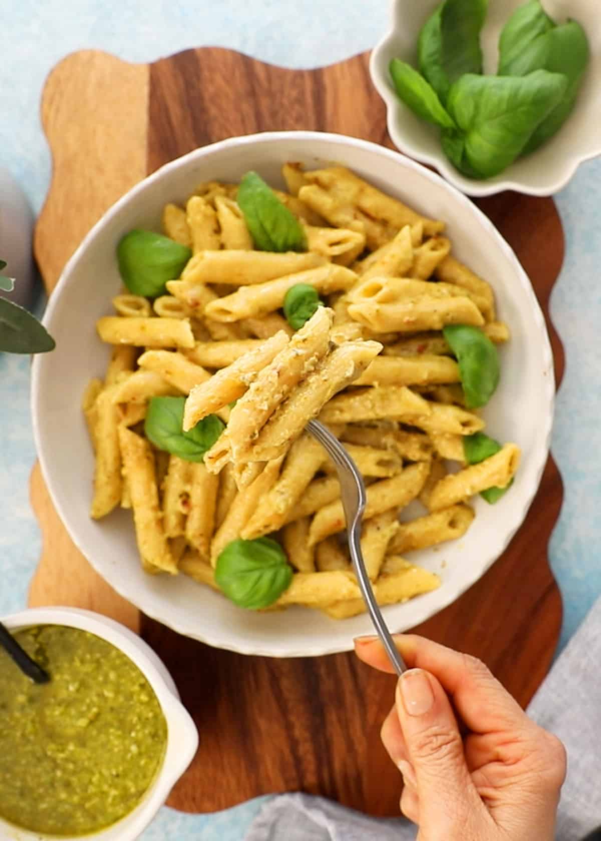 pesto pasta in a white dish.