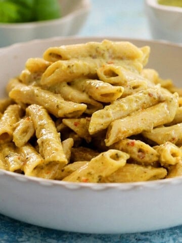 pesto pasta in a white dish.