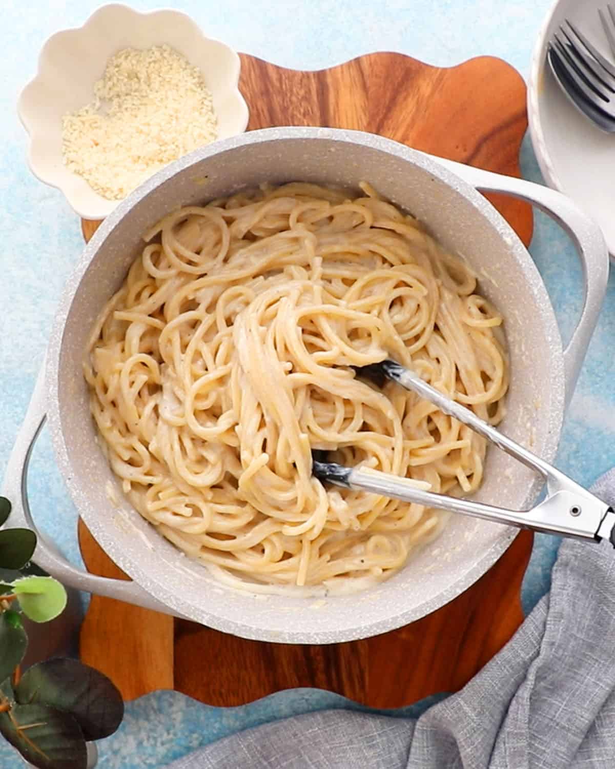 white alfredo pasta in a white pot.