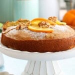 one orange cake in a white cake stand.