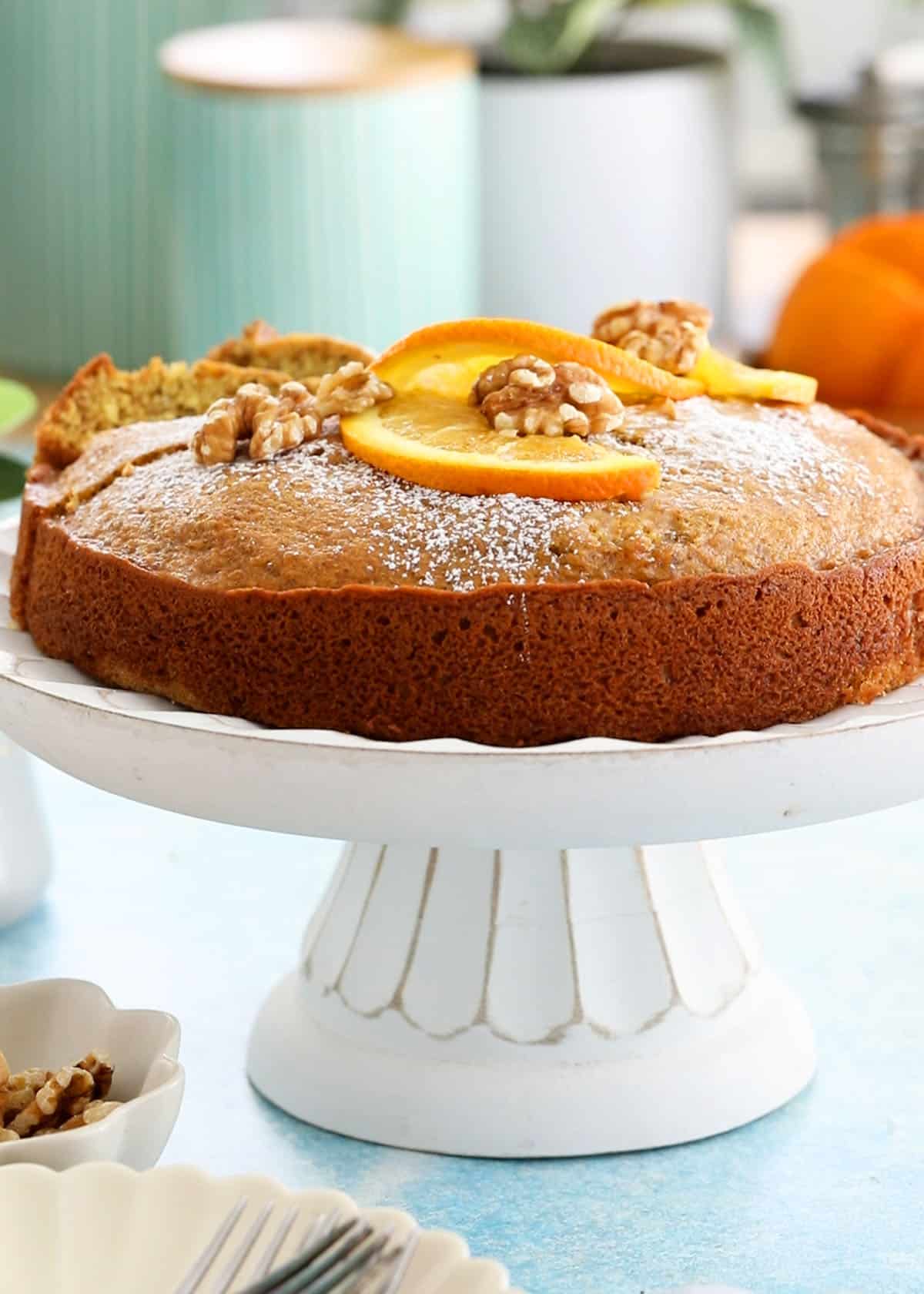 one orange cake in a white cake stand.
