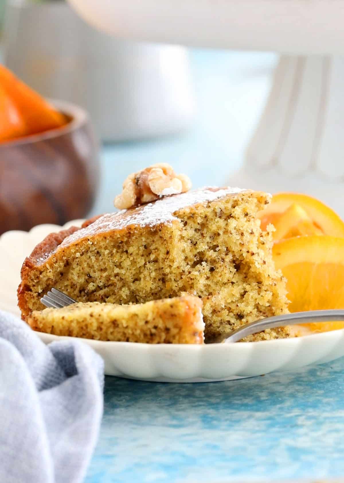 one orange cake slice in a white plate.