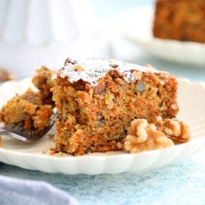 one slice of carrot cake in a white plate.
