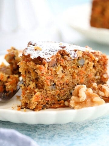 one slice of carrot cake in a white plate.