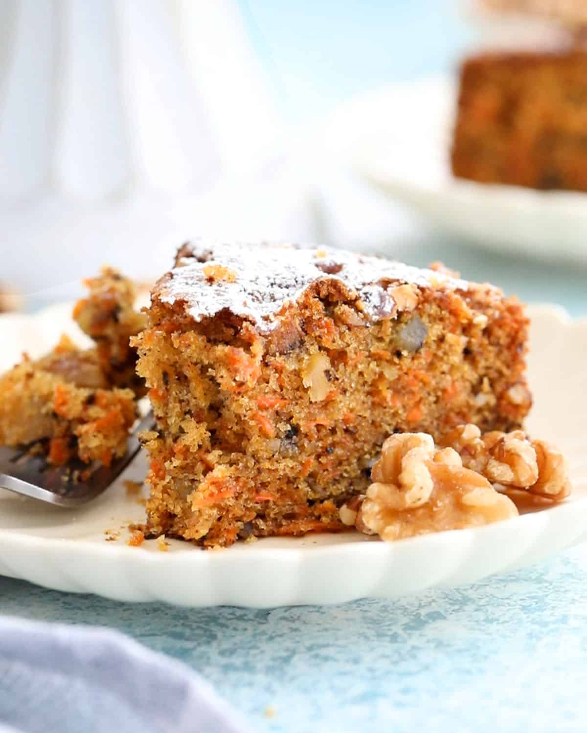 one slice of carrot walnut cake in a white plate.