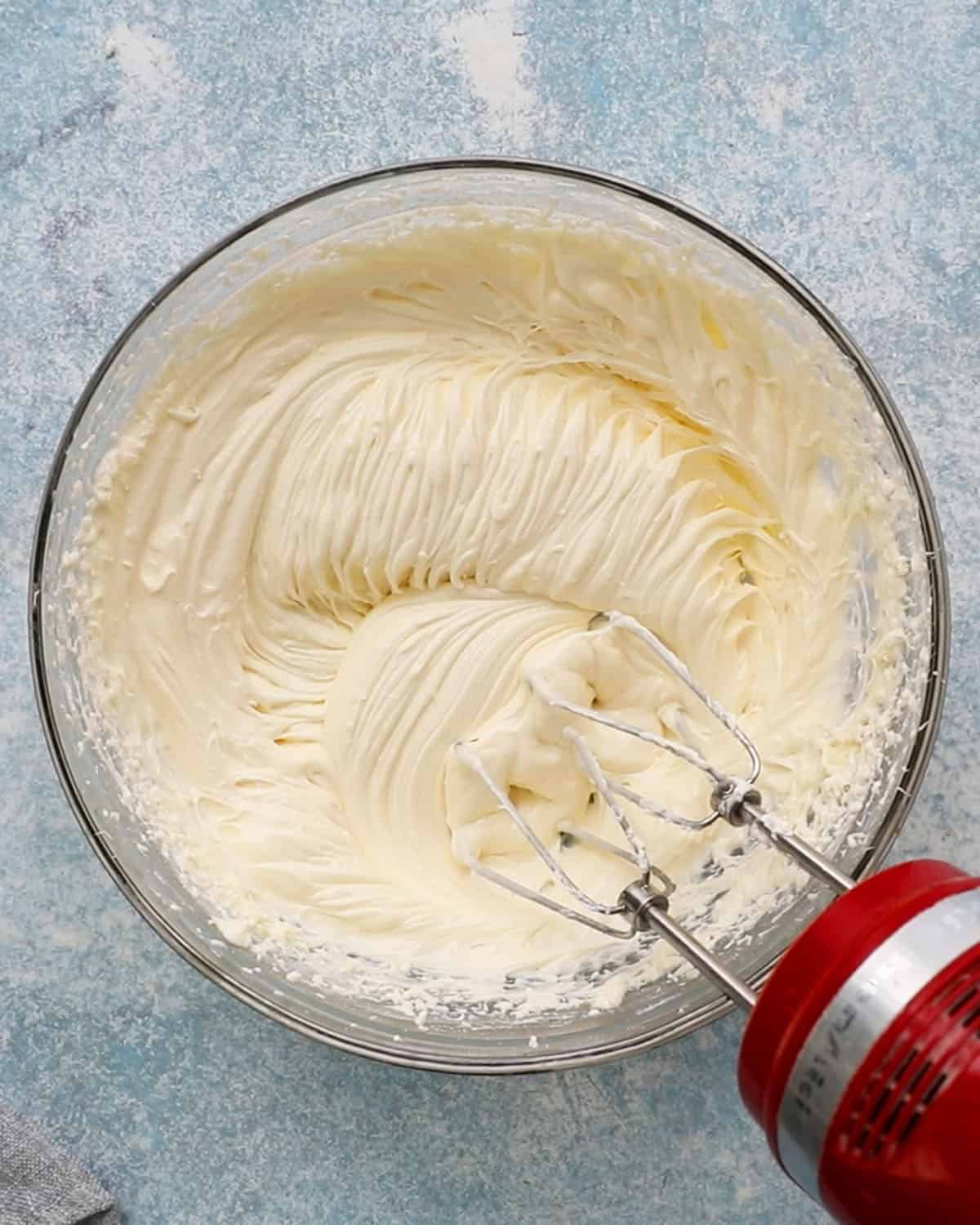 whipped white cream cheese in a glass bowl.