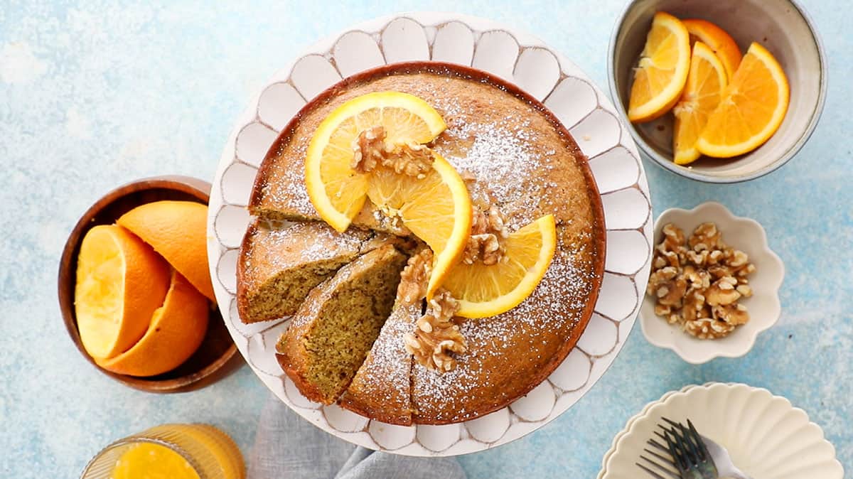 one orange cake in a white cake stand.