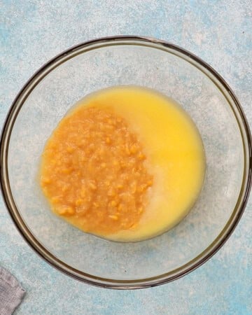 yellow corn mixture in a glass baking bowl.