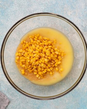 yellow corn mixture in a glass baking bowl.