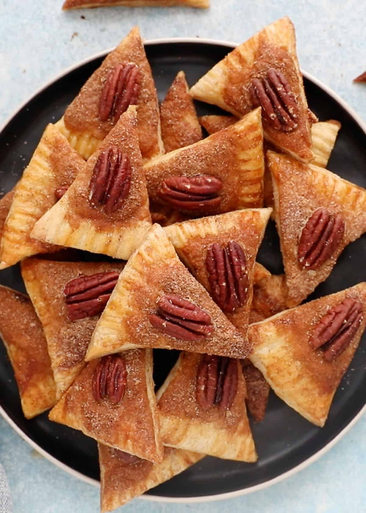 pie crust cookies in a black plate.