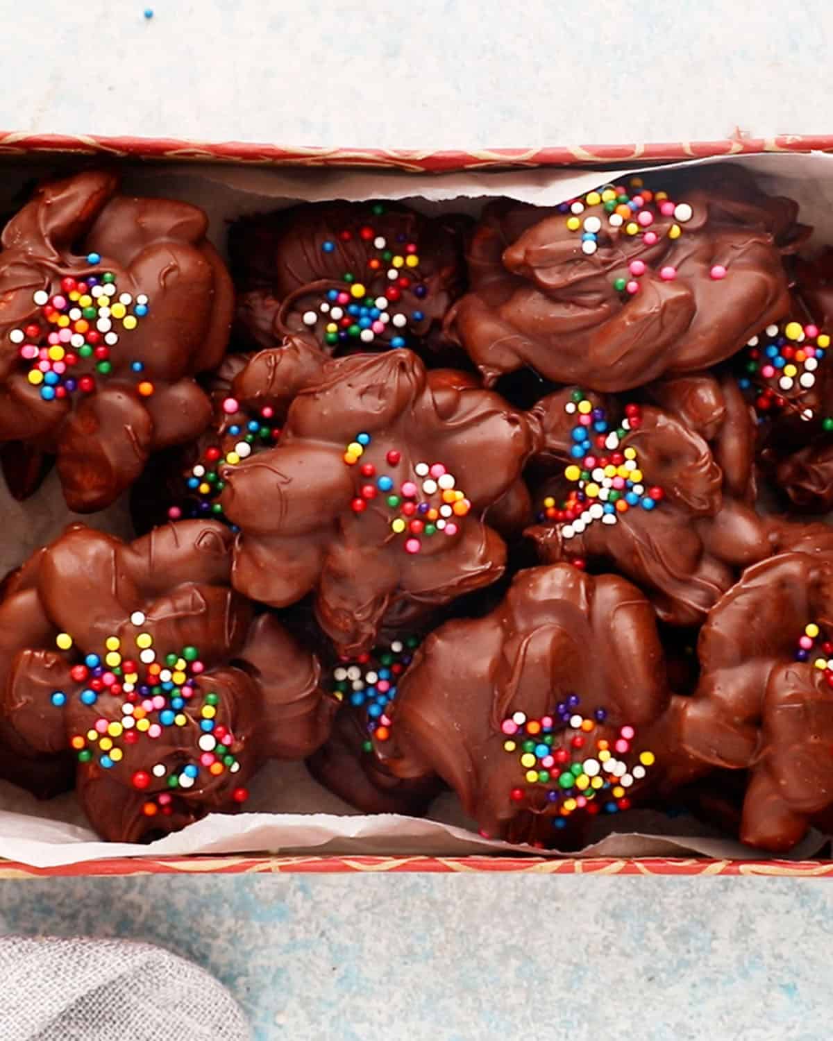 chocolate almond clusters in a red box.