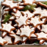 gingerbread star cookies placed in a square wooden tray.