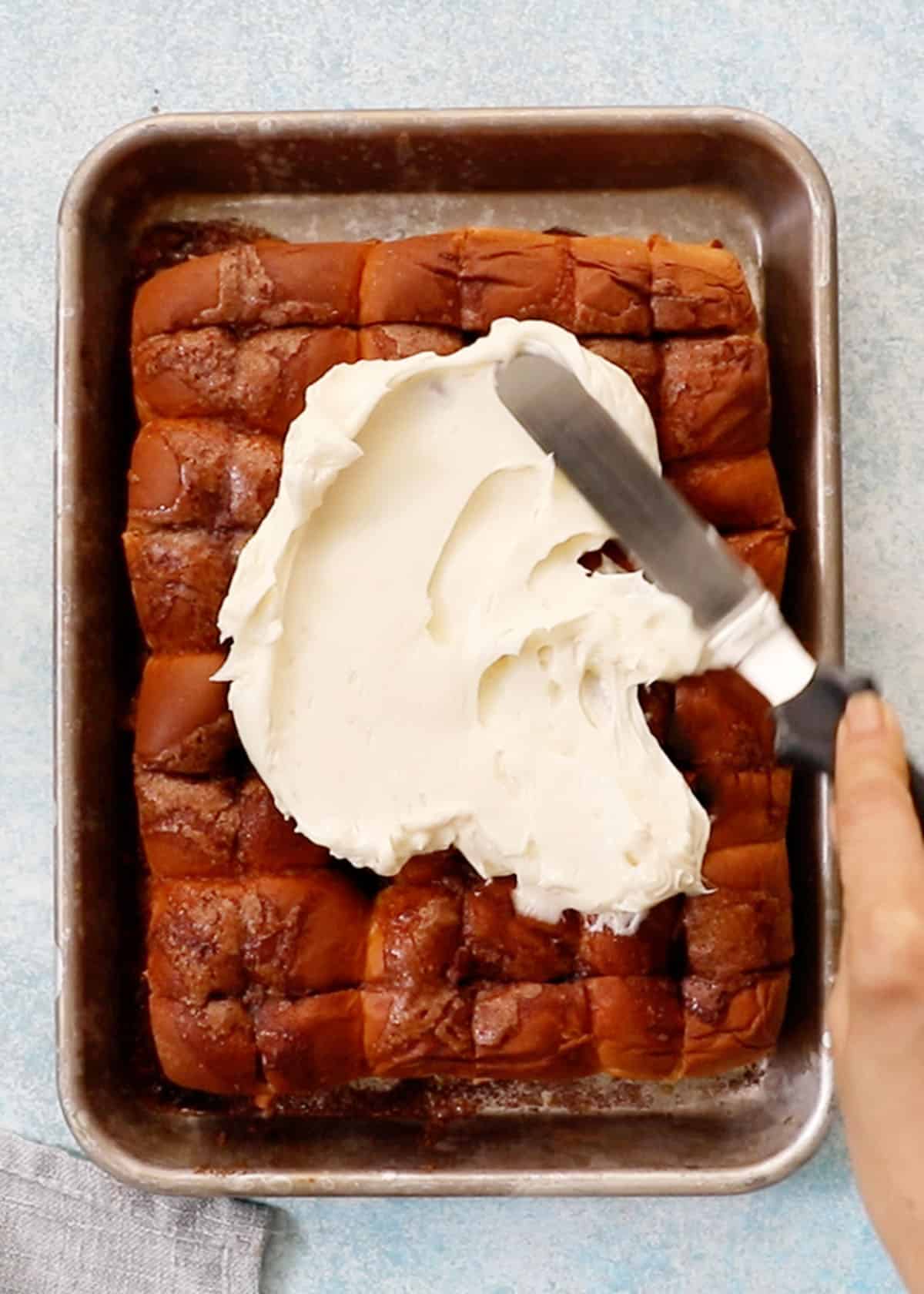 Hawaiian roll cinnamon rolls in a baking sheet.